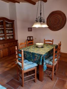 a dining room with a table and chairs at Mas del Salin in Cornudella