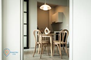 a dining room with a table and chairs at Jesselton Quay by Pinstay in Kota Kinabalu