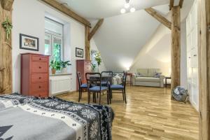 a bedroom with two beds and a table and chairs at Stara Szkola Trzcin 20 in Trzcin