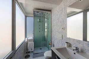 a bathroom with a shower and a toilet and a sink at Guesthouse Pool & Sea Espinho Oporto in Espinho