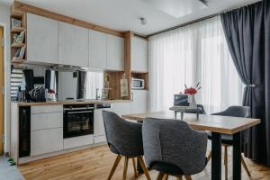 a kitchen with a wooden table and chairs in a room at Weinberg Chalet 2 in Eisenberg an der Pinka