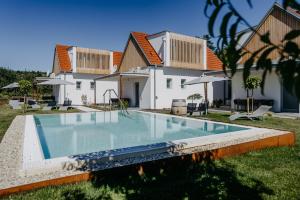 a swimming pool in front of a house at Weinberg Chalet 2 in Eisenberg an der Pinka