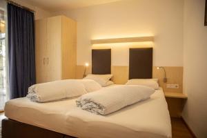 Ein Bett oder Betten in einem Zimmer der Unterkunft Kathrin Apartments - Kapplerhof