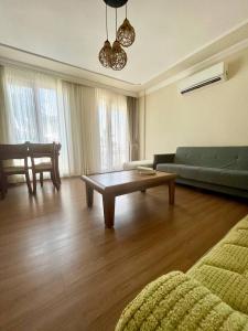 a living room with a couch and a coffee table at Halic Apart Hotel in Yalova