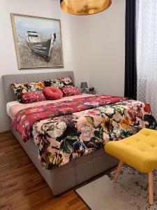 a bedroom with a bed with a colorful comforter at Villa Vida, Medulin - Bazen i jacuzzi in Medulin