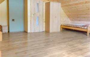 a room with a bed and a wooden floor at Awesome Home In Dolistowo Stare With Kitchen in Dolistowo Stare