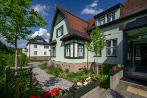 a house with a garden in front of it at Hotel Zelená Marina in Vrchlabí