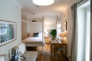 a small bedroom with a bed and a table at Glenview Luss in Luss