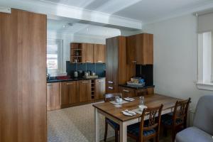 a kitchen with a wooden table and a dining room at Glenview Luss in Luss