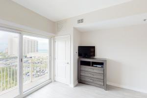 a living room with a tv and a large window at Sandestin Luau 6525 in Destin