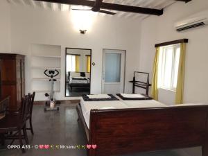 a bedroom with a large bed and a mirror at Z Hotel in Puri