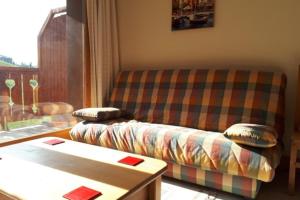 a living room with a couch and a table at Le Chalet de Montalbert 25C in Montalbert