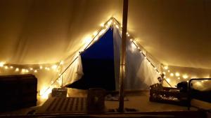 a room with a tent with lights on it at 6 Guests - Bell Tent - Wood Stove - Views in Liverton