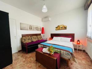 a bedroom with a large bed and a couch at Sogna Venezia in Mestre