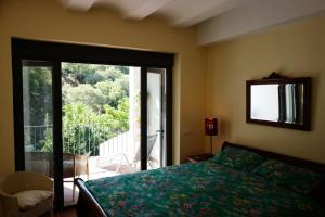 a bedroom with a bed and a sliding glass door at Casa Antonio in Alájar