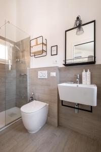 a bathroom with a white sink and a shower at Appartamento vicino all'Orto Botanico by Wonderful Italy in Bologna +17 photos