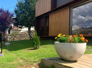 a large concrete planter with flowers in front of a house at Fantástica casa de diseño en Alp in Alp +30 photos