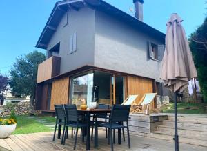 a patio with a table and chairs and an umbrella at Fantástica casa de diseño en Alp in Alp