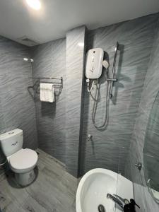 a bathroom with a toilet and a sink and a shower at The Lucky House 1 in Ho Chi Minh City