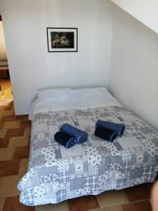 a bed with two blue pillows on top of it at Lina in Gradac