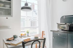a kitchen with a table with food and a microwave at The Art Room Apartment in Cardigan
