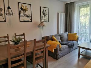 a living room with a couch and a table at Apartament w parku in Oświęcim