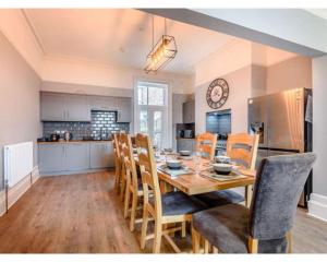 a kitchen and dining room with a table and chairs at Victoria House in Southport
