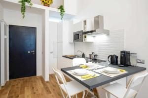a kitchen with a table and chairs in a kitchen at Milano City Apartments - Duomo Brera - Elegant Suite in Design District in Milan