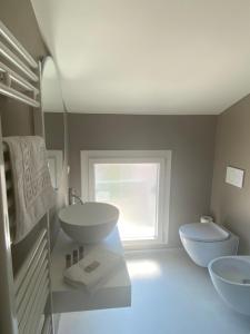 a bathroom with two sinks and a toilet at Cà del Faro in Fano