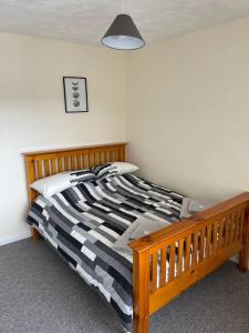 a bedroom with a wooden bed in a room at Sea Breeze is next to the Beach & Harbour in Harwich