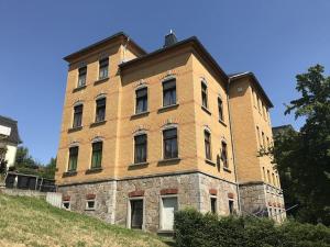 a large brick building on top of a hill at Gemütliche Wohnung mit Küche und Netflix in Klingenthal