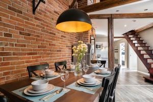 a dining room with a brick wall at be HAPPY Apartments in Kraków