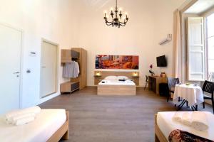 a bedroom with a bed and a desk in a room at Ballaro' Hotel - Budget Room in Palermo