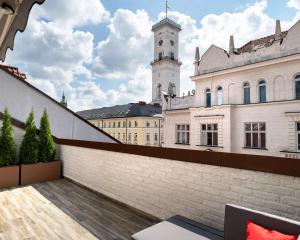 a view from the rooftop of a building with a clock tower at Best Western Plus Market Square Lviv in Lviv