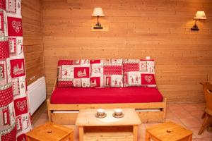 a room with a bed in a wooden room at Chalets de Praroustan by Actisource in Pra-Loup