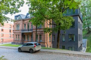a small car parked in front of a building at Vallikraavi Lux Apartment in Tartu