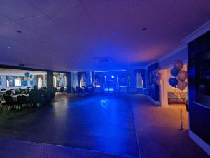 a blue room with a dance floor and balloons at Hotel Celebrity Bournemouth East Cliff by Villare hotels in Bournemouth