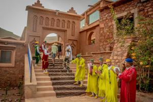 a group of people standing outside of a building at Ouednoujoum Ecolodge & Spa in Ouarzazate