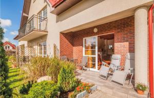 eine Terrasse eines Hauses mit Stühlen darauf in der Unterkunft Cozy Apartment In Rowy With Kitchen in Rowy