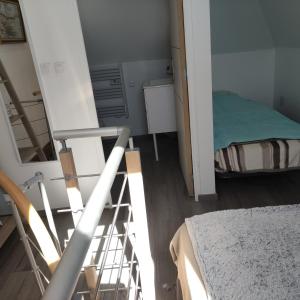 Ένα ή περισσότερα κρεβάτια σε δωμάτιο στο Le petit gîte d'Angélique