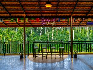 un gruppo di sedie e tavoli su un balcone di The Hosteller Coorg Rainforest, Madikeri a Madikeri