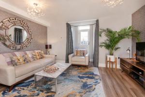 a living room with a couch and a mirror at 8 Blue Bridge- Elegant and Luxurious 1 Bedroom Apt- Free Parking in York