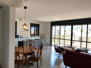 a kitchen and living room with a table and chairs at PORT CITY HAIFA - Bat Galim 20m from the beach in Haifa