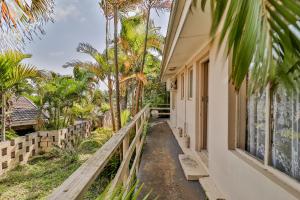 a house with a walkway next to a building at St Lucia Safari Lodge Holiday Home in St Lucia