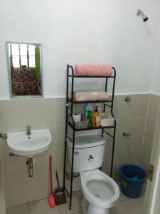 a bathroom with a toilet and a sink at Budget Home in Iloilo Staycation At 8 Pax in Oton