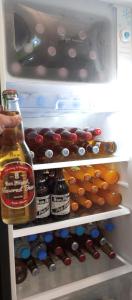 an open refrigerator filled with lots of drinks and food at Budget Home in Iloilo Staycation At 8 Pax in Oton