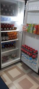 an open refrigerator filled with lots of food and drinks at Budget Home in Iloilo Staycation At 8 Pax in Oton
