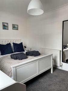 a bedroom with a bed with two pillows on it at Tidal Walk Cottage by the Sea in Harwich