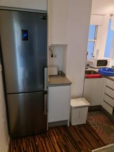 a stainless steel refrigerator in a small kitchen at APARTAMENTO VALERIA in Murcia