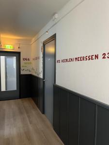 a room with a door and a sign on the wall at Hotel Gaudi in Valkenburg